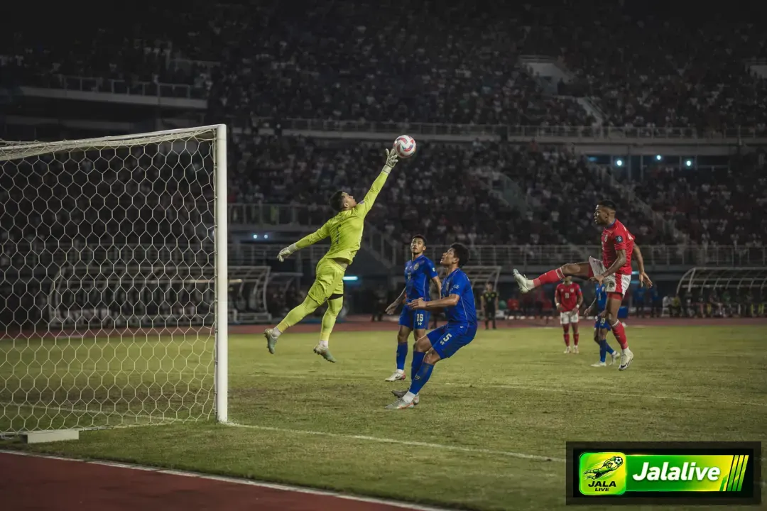 Penjaga gawang melakukan penyelamatan dalam pertandingan sepak bola di Indonesia